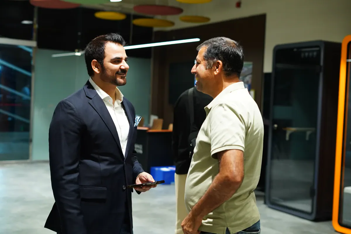 Global Syndicate founder Abid Ali Khan speaking with a community member